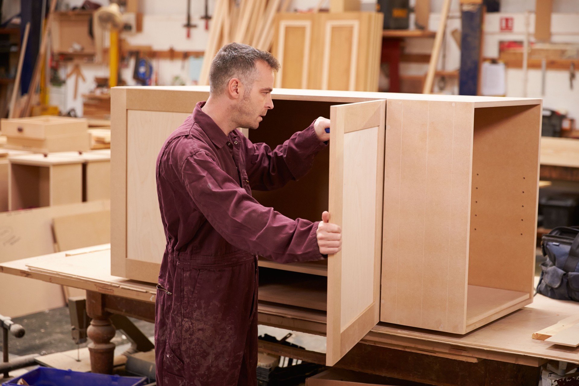 A carpenter building furniture in a workshop